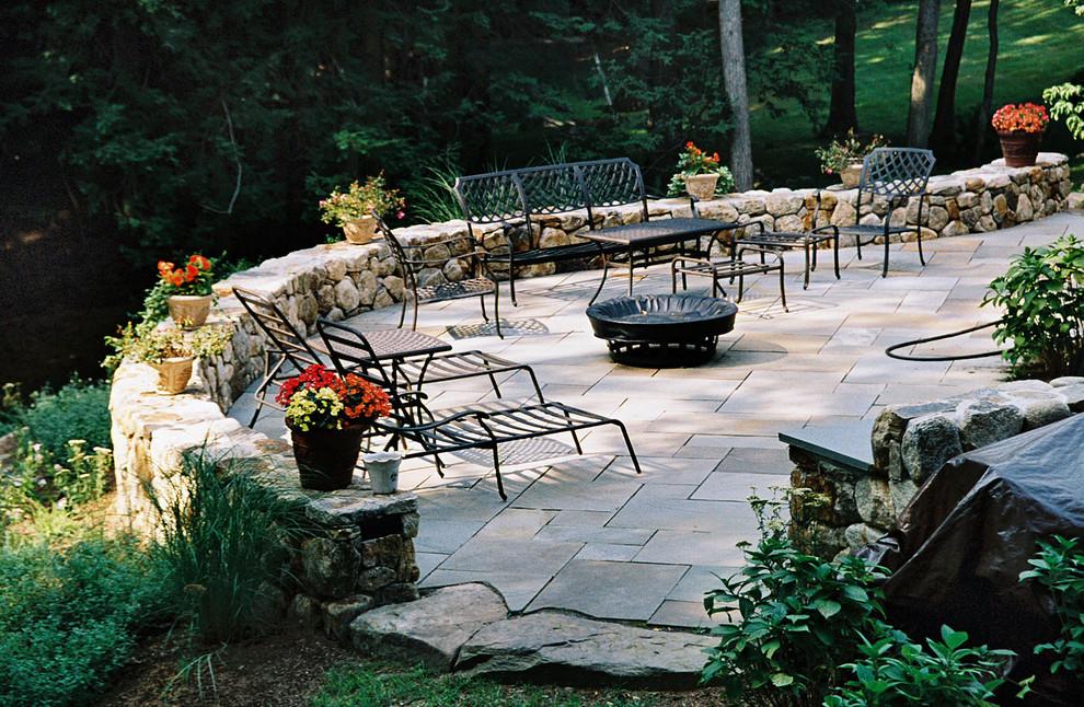 A curved stone retaining wall adds extra seating Traditional Patio
