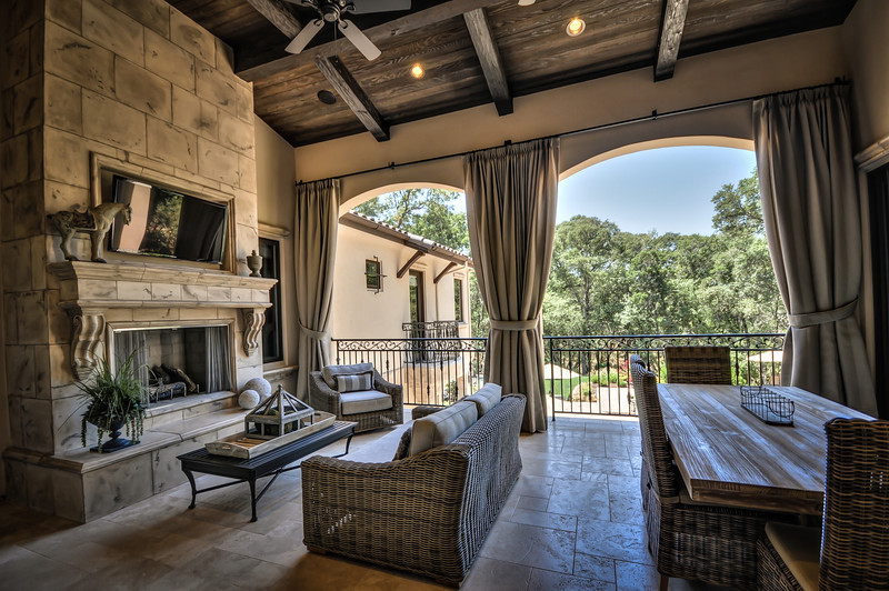 Large tuscan backyard tile patio photo in Sacramento with a fireplace and a roof extension