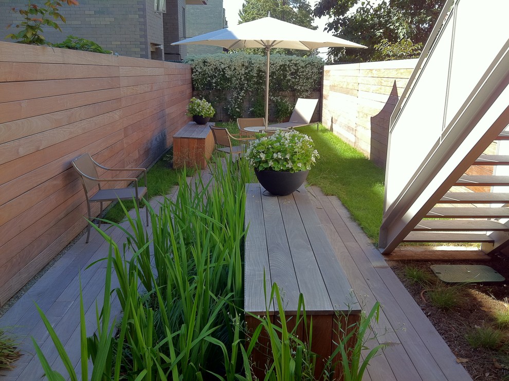 Contemporary patio in New York with decking and fencing.