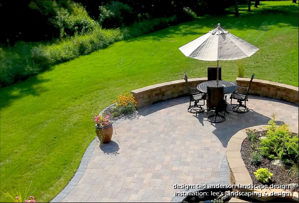 Design ideas for a traditional back patio in Minneapolis with concrete paving.