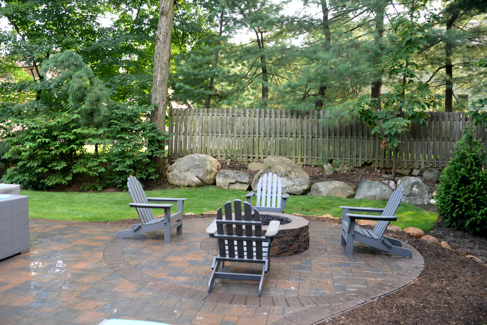This is an example of a small classic back patio in Other with a fire feature and concrete paving.