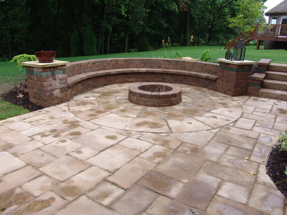 Example of a mid-sized classic backyard concrete paver patio design in Chicago with a fire pit