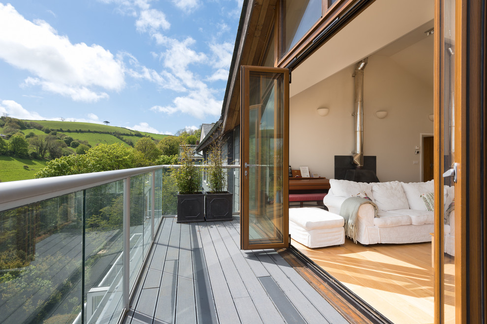 Photo of a medium sized back patio in Devon with a water feature and decking.