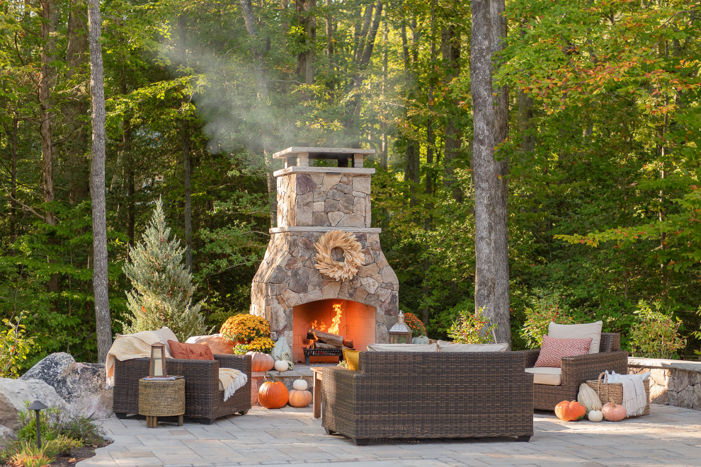Inspiration for a large timeless backyard concrete paver patio remodel in Richmond with a fireplace