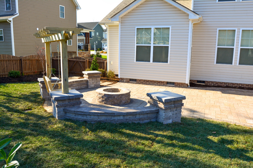 Inspiration for a mid-sized timeless backyard concrete paver patio remodel in Richmond with a fire pit and no cover