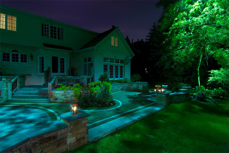 Example of a transitional backyard stamped concrete patio kitchen design in Chicago