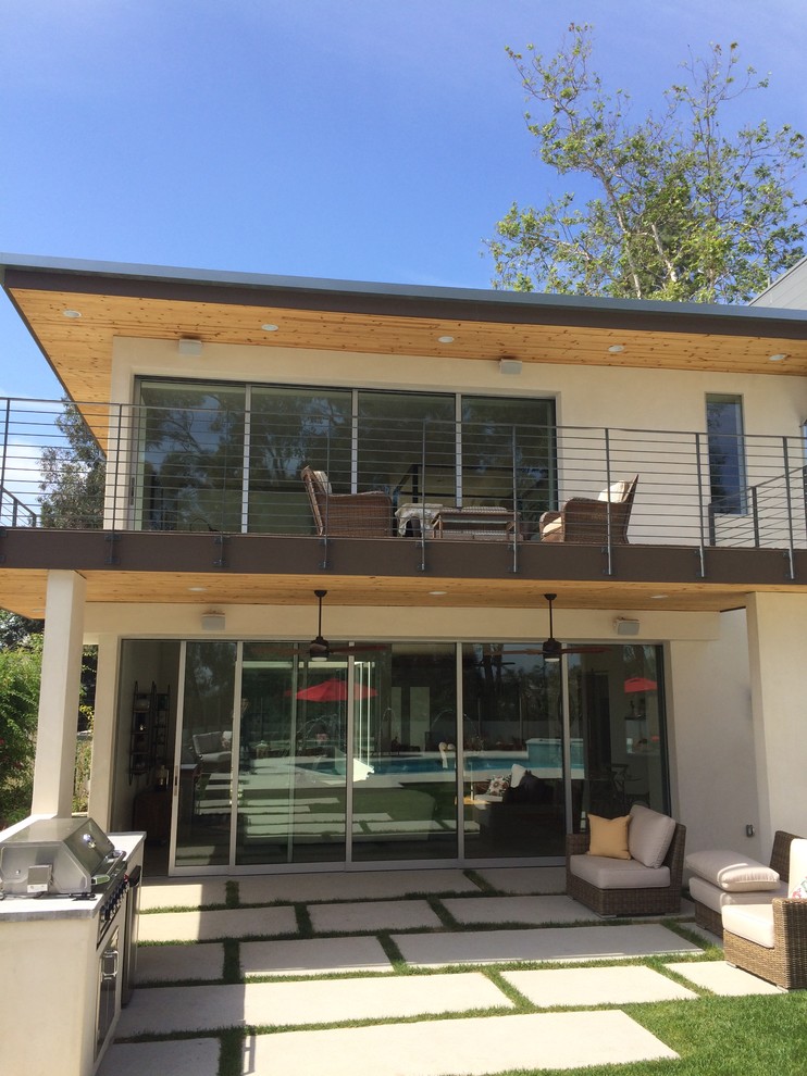 This is an example of a medium sized contemporary back patio in Los Angeles with brick paving.