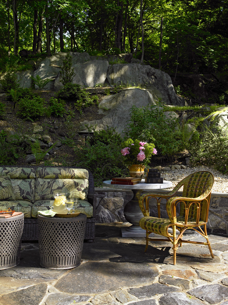 Mid-sized mountain style side yard stone patio photo in New York