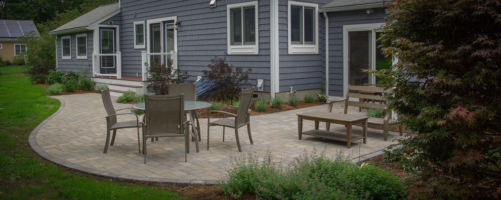 Photo of a traditional back patio in Boston with concrete paving.
