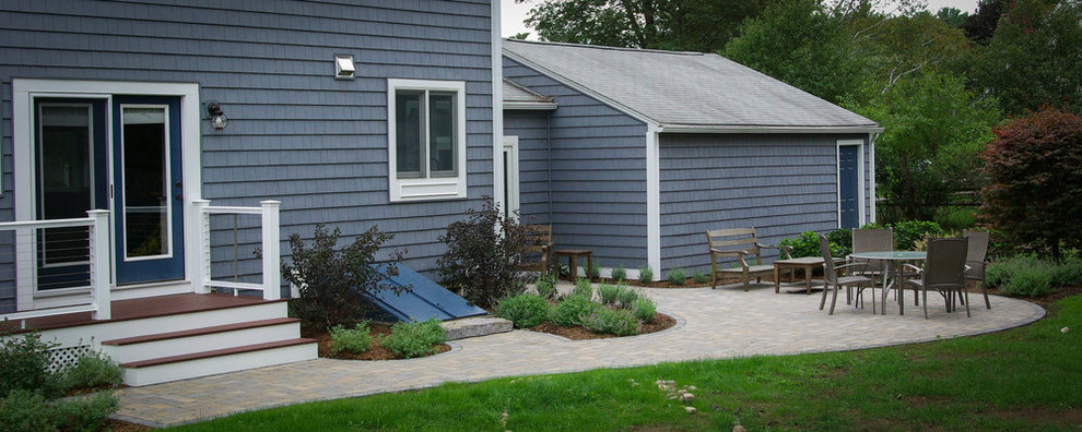 Design ideas for a traditional back patio in Boston with concrete paving.