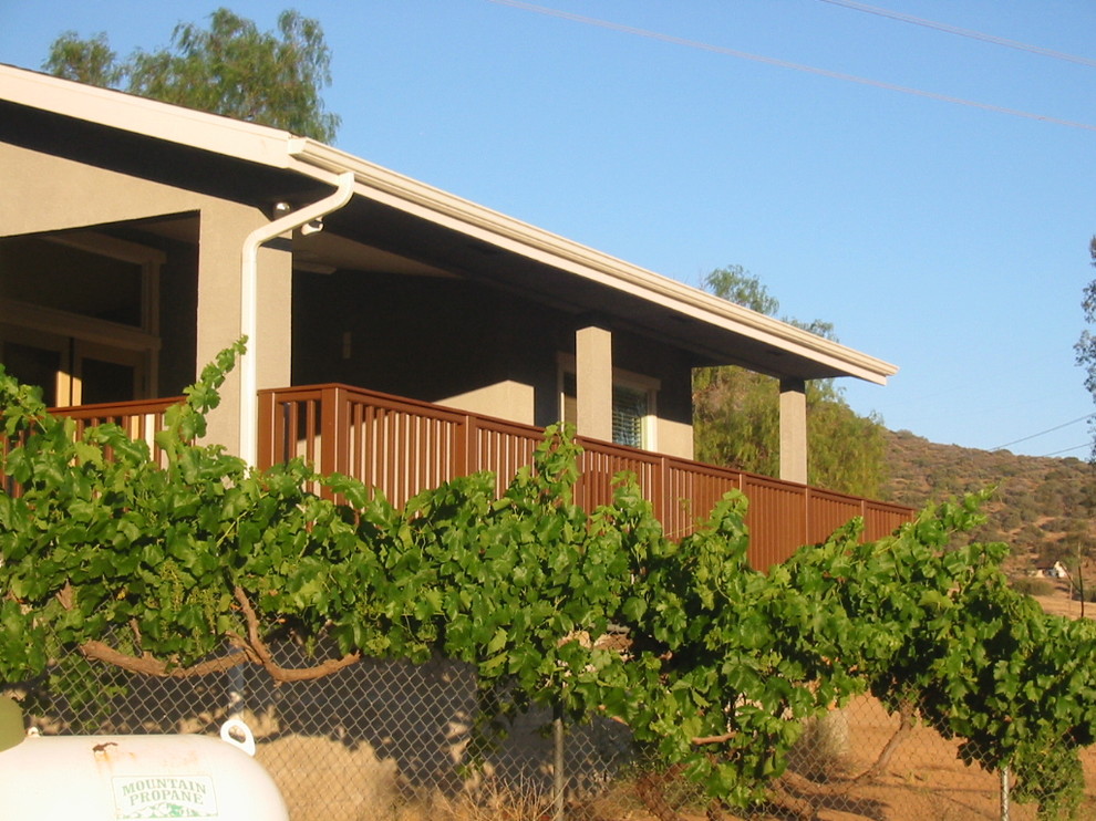 Inspiration for a medium sized classic side patio in Los Angeles with a roof extension.