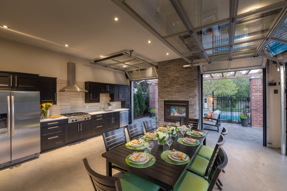 Example of a trendy backyard patio kitchen design in Toronto with a roof extension