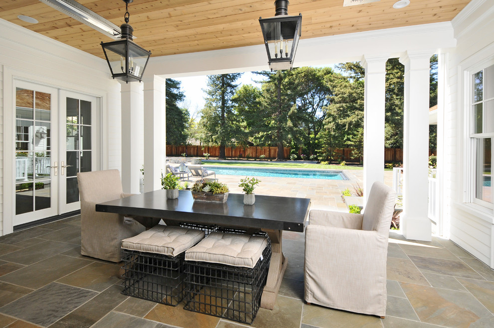 Traditional courtyard patio in San Francisco with a roof extension.