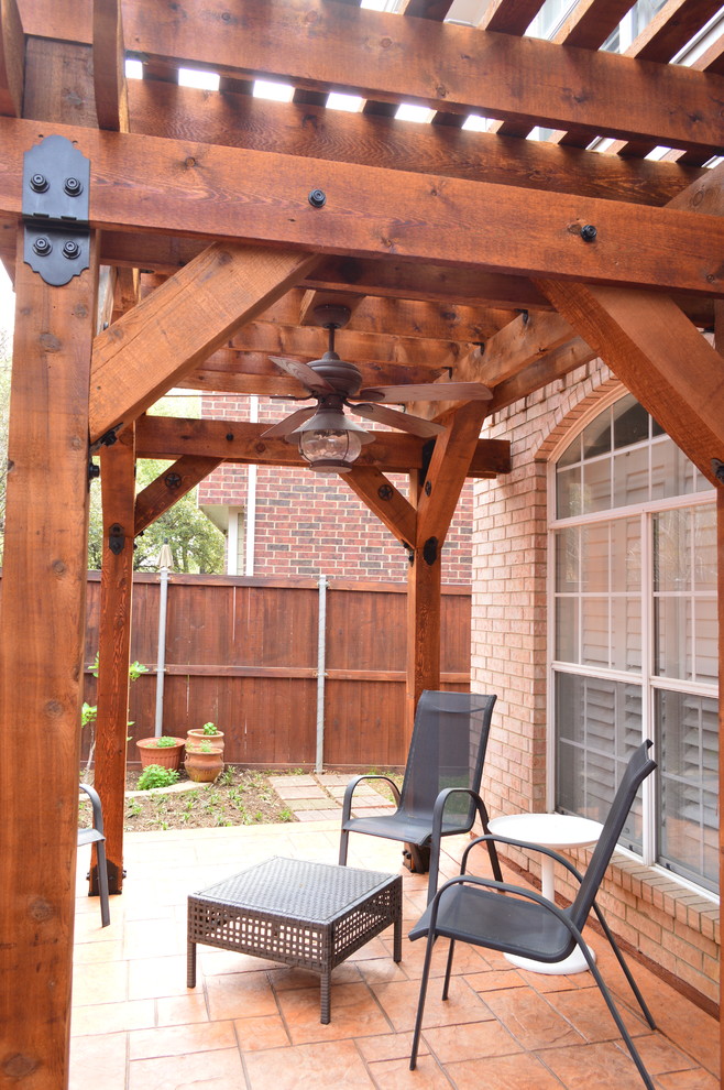 Inspiration for a medium sized rustic side patio in Dallas with stamped concrete and a pergola.