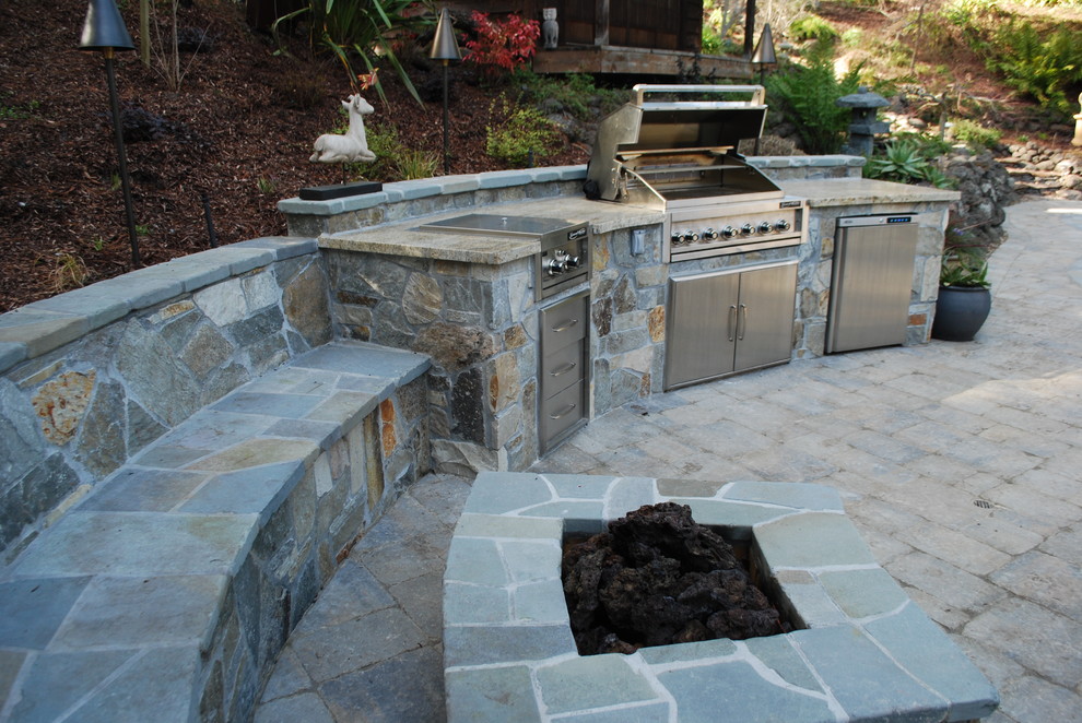 Medium sized classic back patio in San Francisco with an outdoor kitchen, natural stone paving and no cover.
