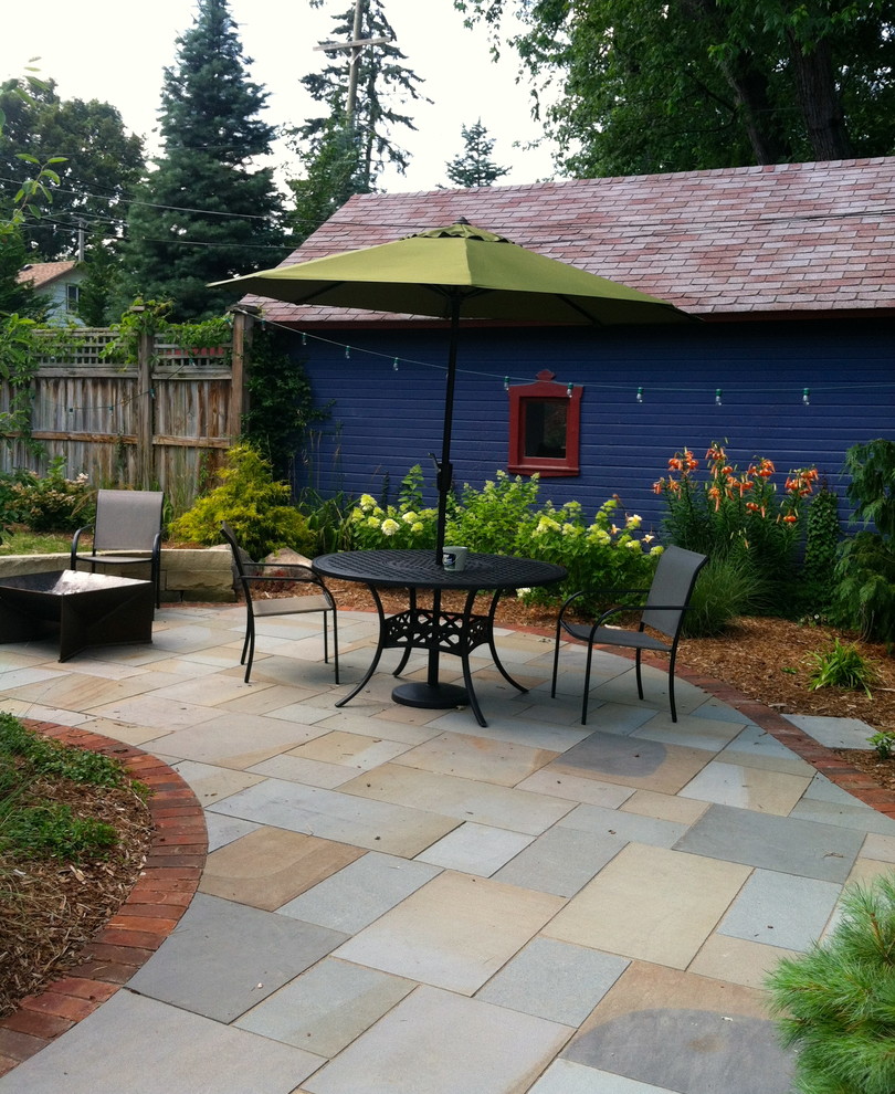 Ejemplo de patio romántico de tamaño medio sin cubierta en patio trasero con adoquines de piedra natural y brasero