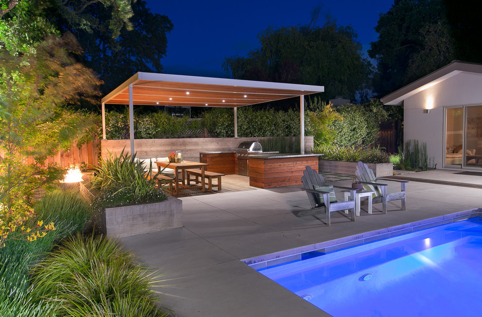 Large contemporary back patio in San Francisco with an outdoor kitchen and concrete paving.