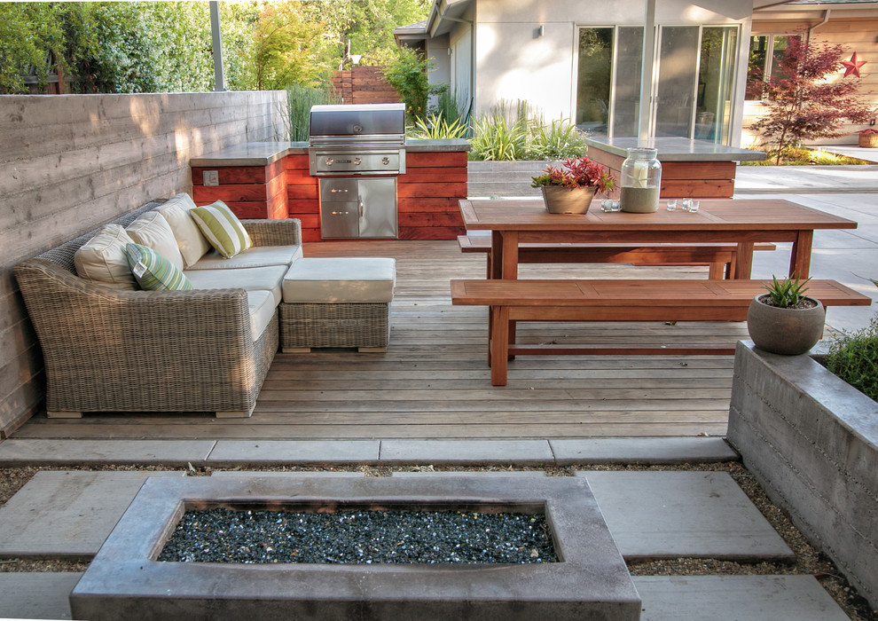 This is an example of a large contemporary back patio in San Francisco with an outdoor kitchen and concrete paving.