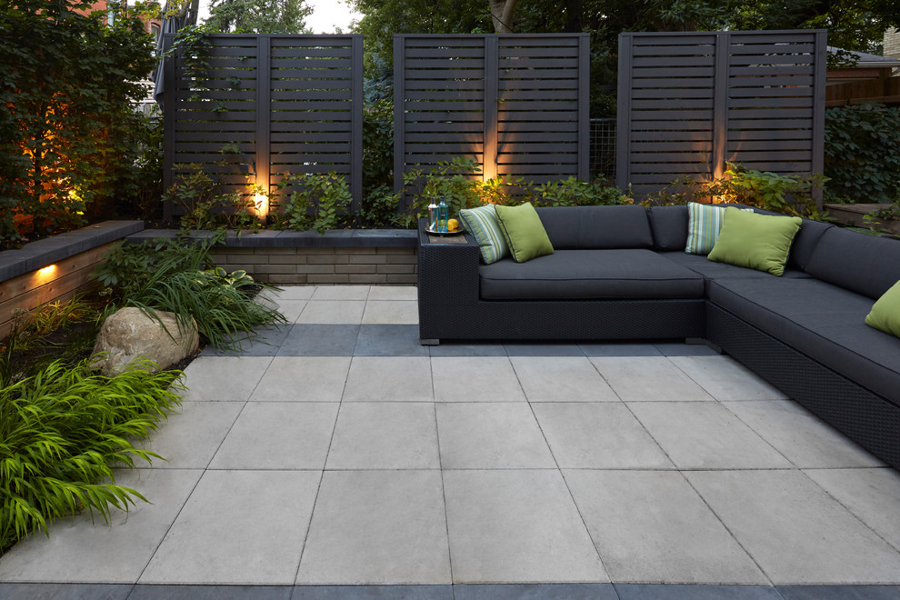 Inspiration for a modern patio in Toronto with concrete slabs and no cover.