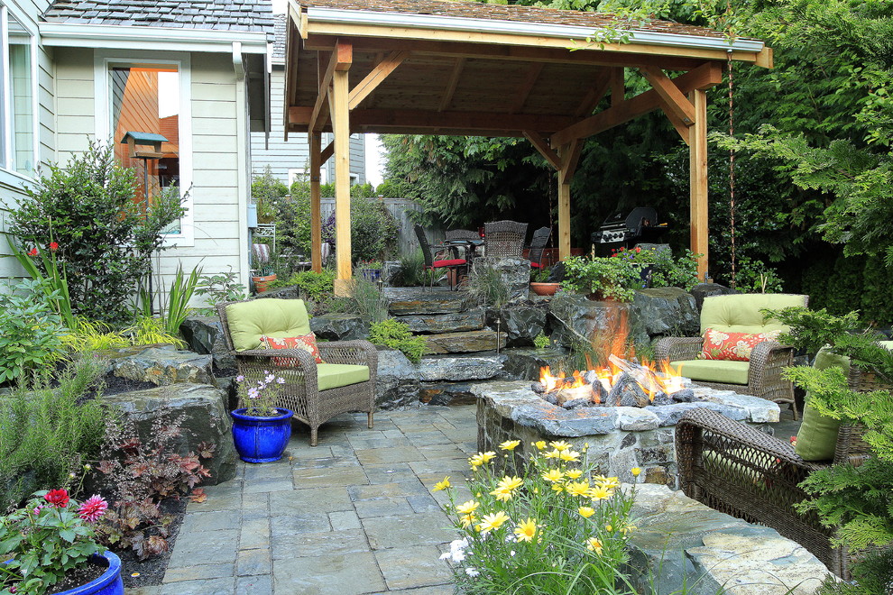 This is an example of a traditional patio in Seattle with a fire feature and a gazebo.