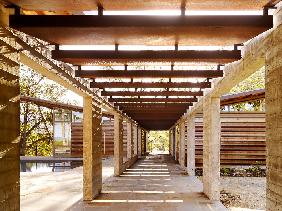 Trendy courtyard concrete paver patio photo in San Francisco with a pergola