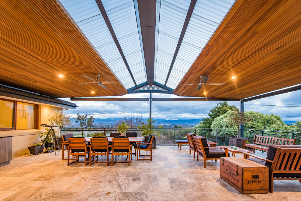 Large contemporary patio in Canberra - Queanbeyan with an outdoor kitchen, tiled flooring and a pergola.