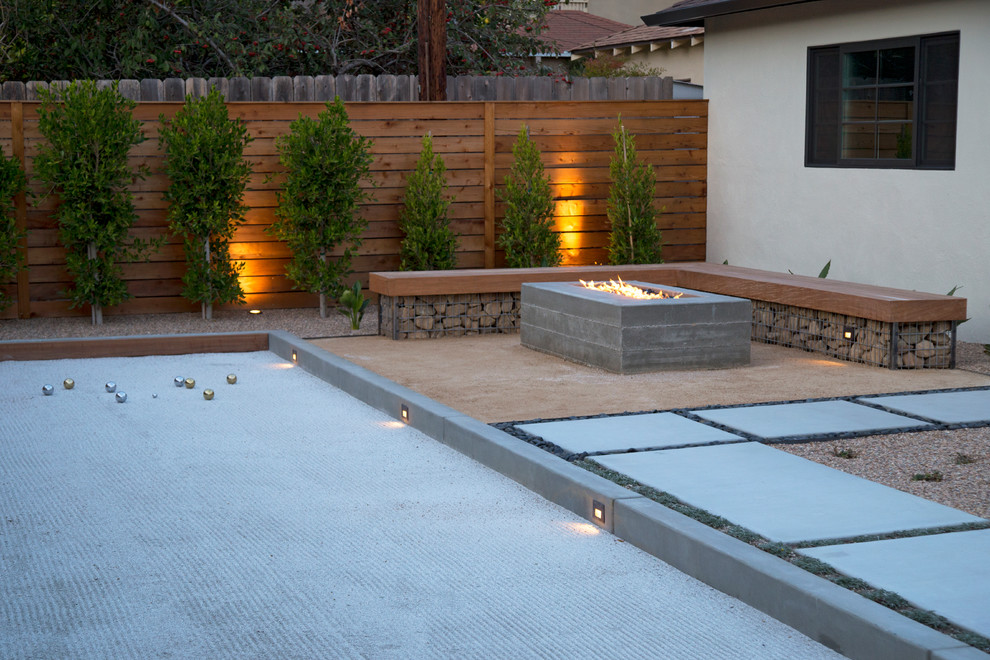 Example of a large minimalist backyard concrete patio kitchen design in San Luis Obispo with a pergola