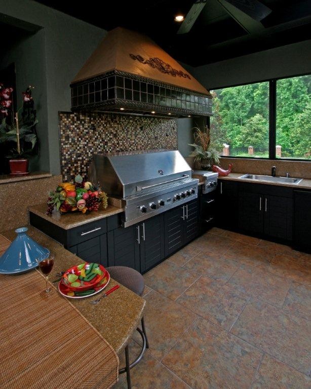 Inspiration for a large contemporary backyard tile patio kitchen remodel in Jacksonville with a roof extension