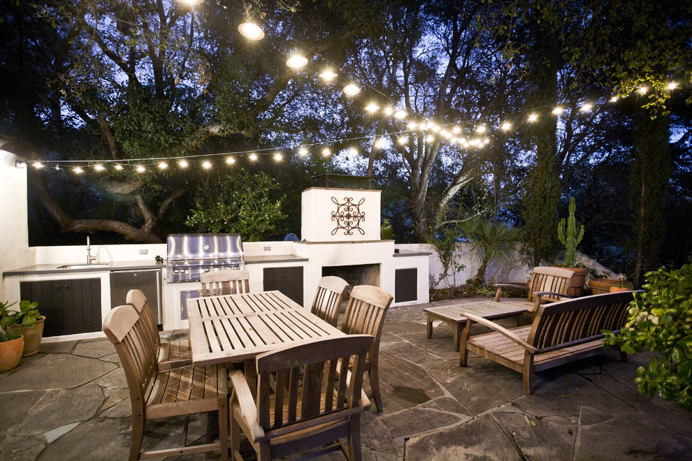 Patio kitchen - mid-sized contemporary backyard stone patio kitchen idea in Los Angeles with no cover