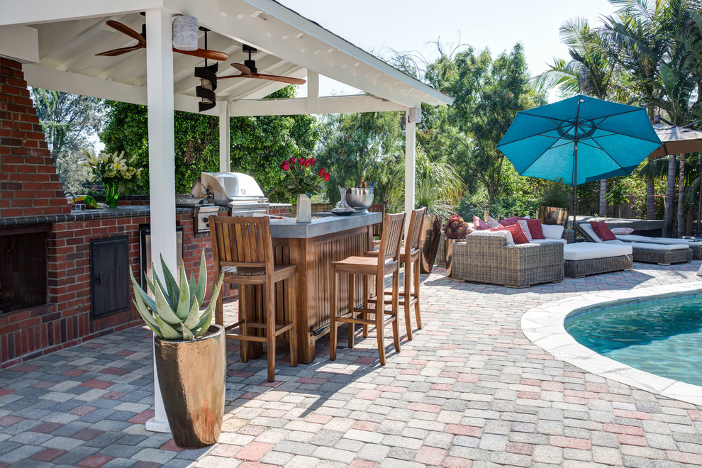 Inspiration for a classic back patio in Los Angeles with an outdoor kitchen, brick paving and a gazebo.