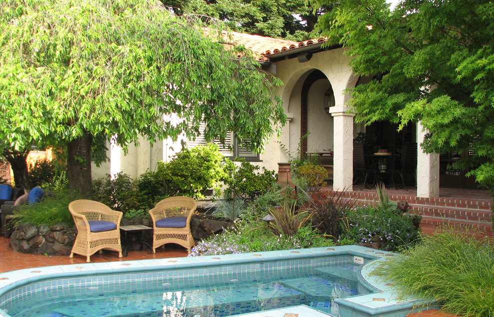 Diseño de patio mediterráneo de tamaño medio sin cubierta en patio trasero con suelo de baldosas
