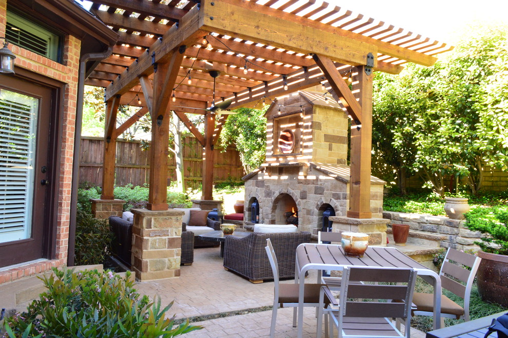 Mittelgroße Mediterrane Pergola hinter dem Haus mit Feuerstelle und Natursteinplatten in Dallas