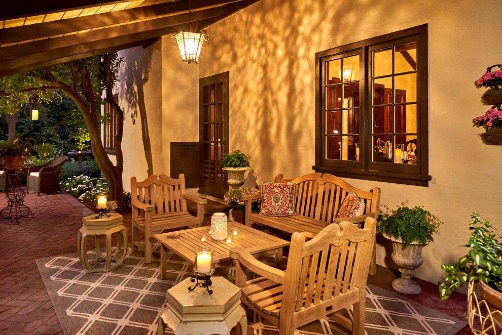 Design ideas for an expansive traditional back patio in San Francisco with a fire feature, brick paving and a pergola.