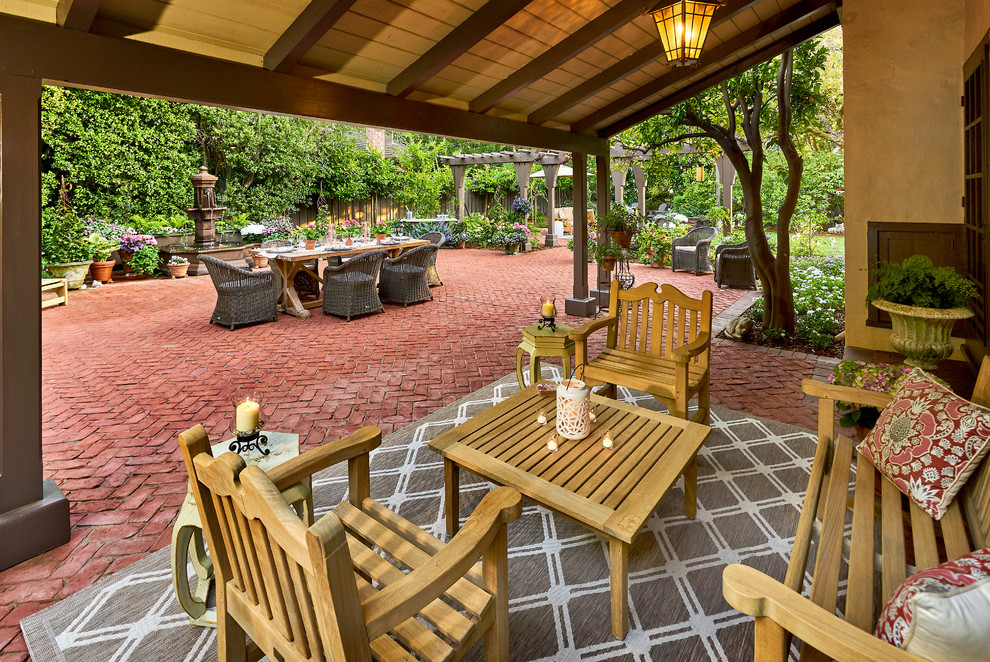 Inspiration for a huge timeless backyard brick patio remodel in San Francisco with a fire pit and a pergola