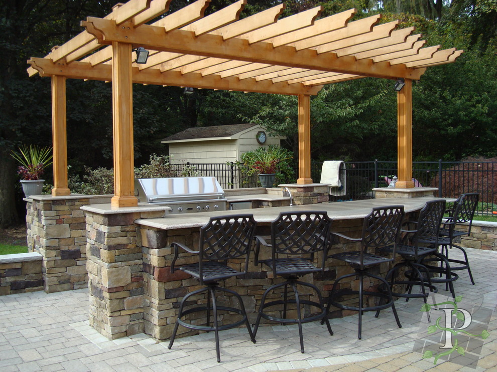 An outdoor kitchen with bar - Traditional - Patio - New York - by ...