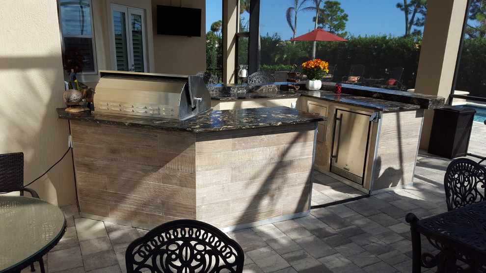 Large mediterranean back patio in Jacksonville with an outdoor kitchen.