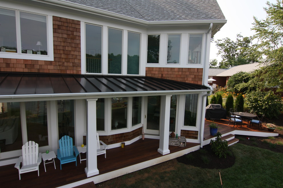 Cette photo montre une terrasse arrière bord de mer avec une extension de toiture et une cuisine d'été.
