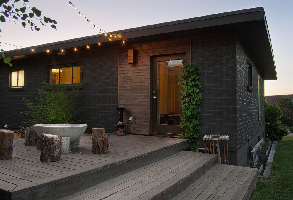 Example of a mid-sized trendy backyard patio design in Salt Lake City with a fire pit, decking and no cover