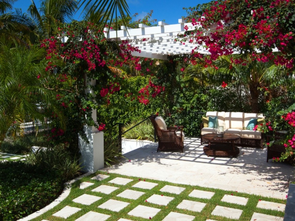 Inspiration for a mid-sized coastal backyard concrete paver patio remodel in Miami with no cover