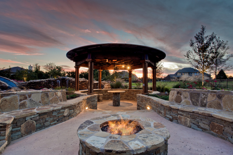 Patio - tropical backyard patio idea in Dallas with a fire pit