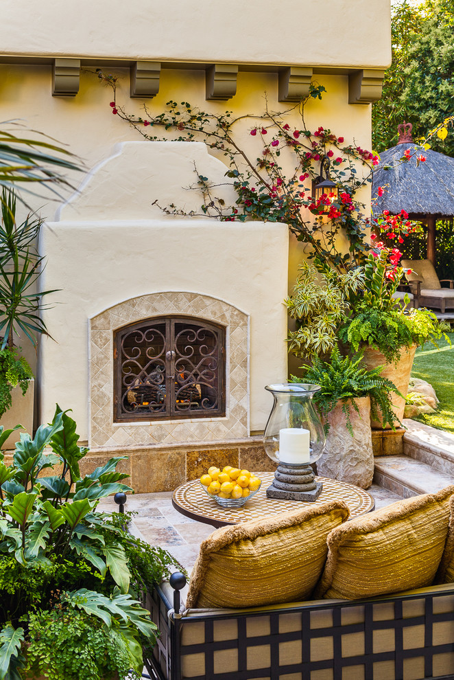 Design ideas for a medium sized mediterranean back patio in Santa Barbara with a fire feature and no cover.