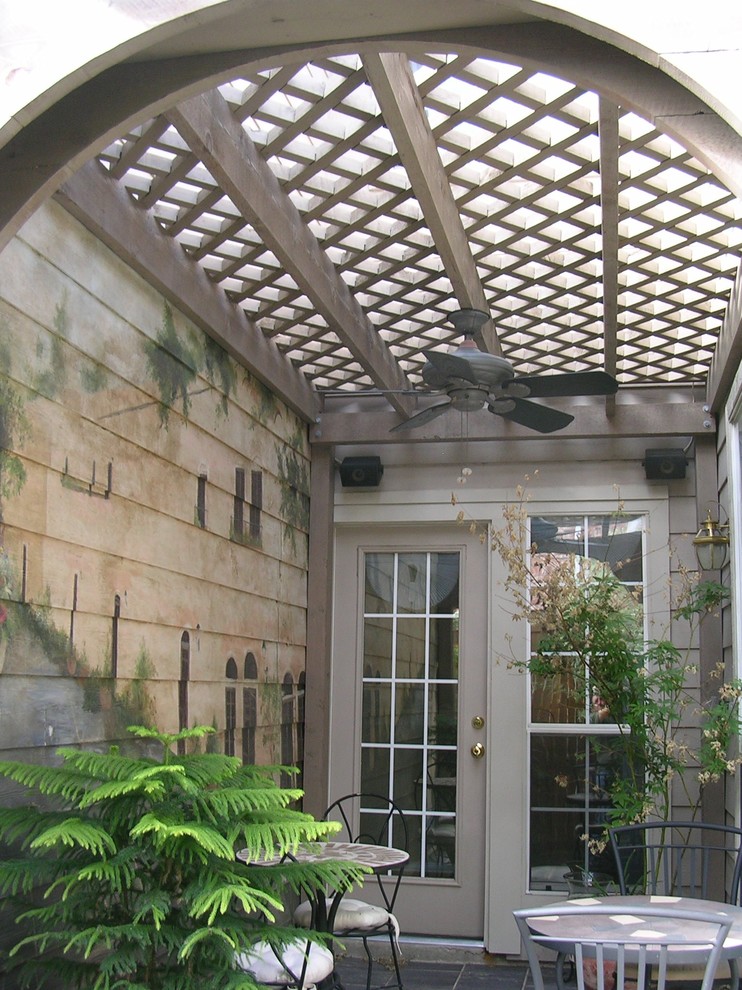 Patio - small craftsman courtyard tile patio idea in Dallas with a pergola
