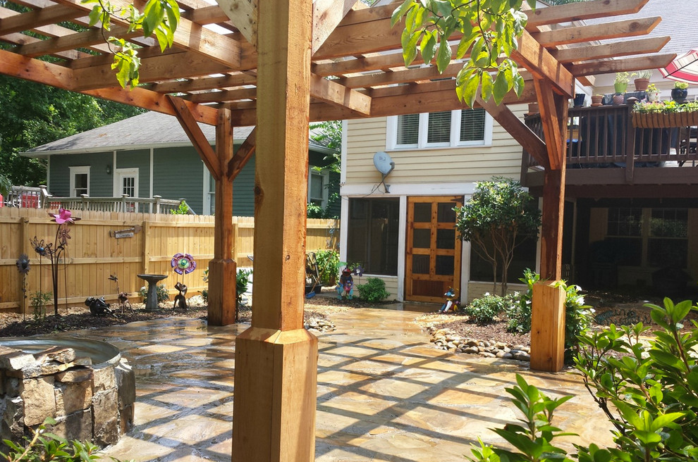 Courtyard patio in Atlanta with stamped concrete and a pergola.