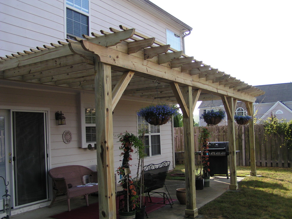 Inspiration for a mid-sized rustic backyard concrete patio remodel in Atlanta with a pergola