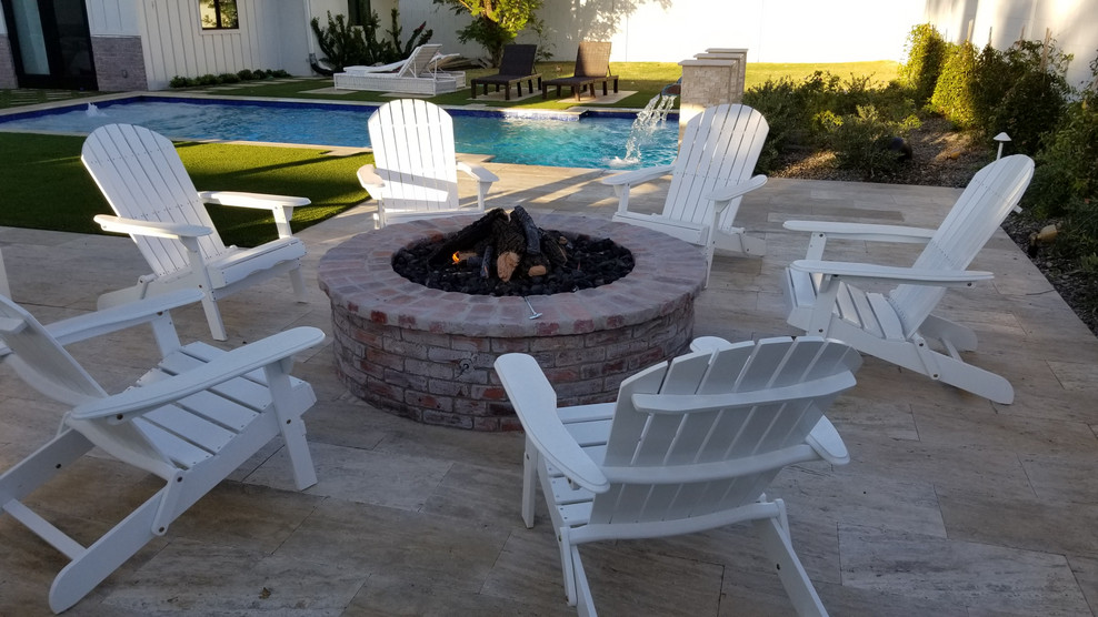Photo of a medium sized farmhouse back patio in Phoenix with a fire feature, tiled flooring and a pergola.