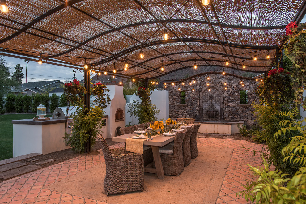 Modelo de patio mediterráneo extra grande en patio trasero con cocina exterior, pérgola y adoquines de ladrillo
