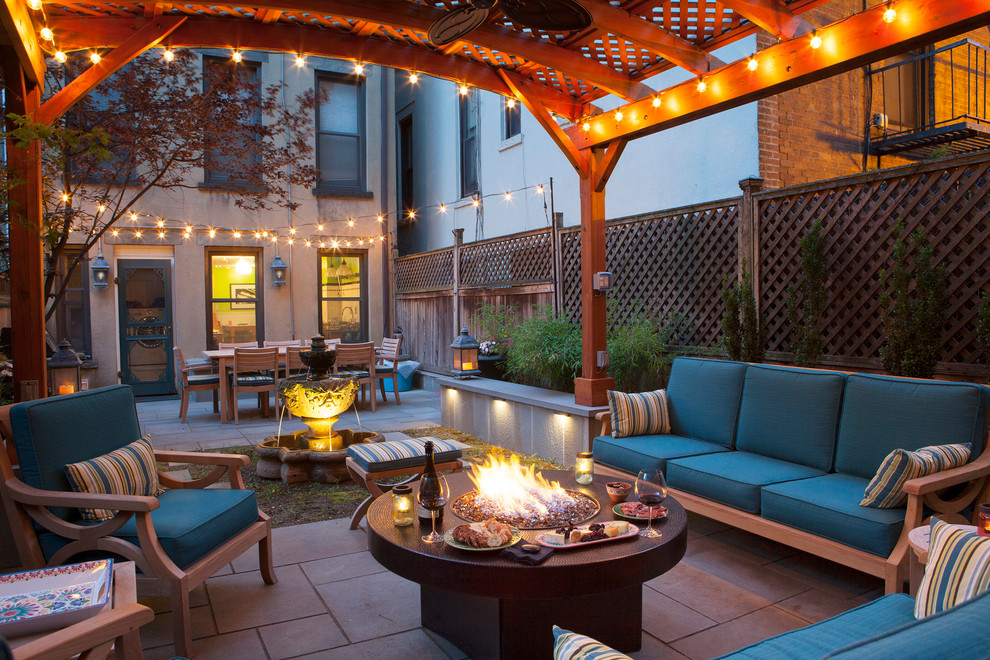 Transitional backyard patio photo in San Francisco with a fire pit and a gazebo