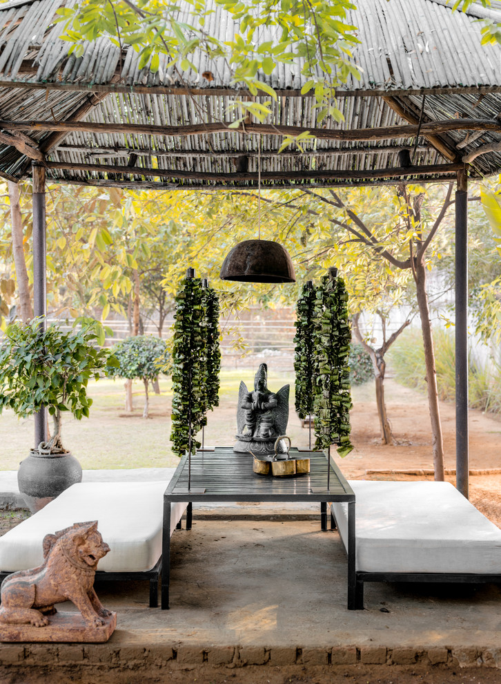 World-inspired back patio in Delhi with a gazebo.