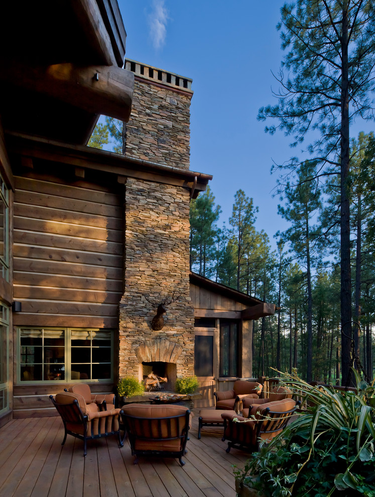 Patio - large rustic backyard patio idea in Phoenix with decking, a roof extension and a fire pit