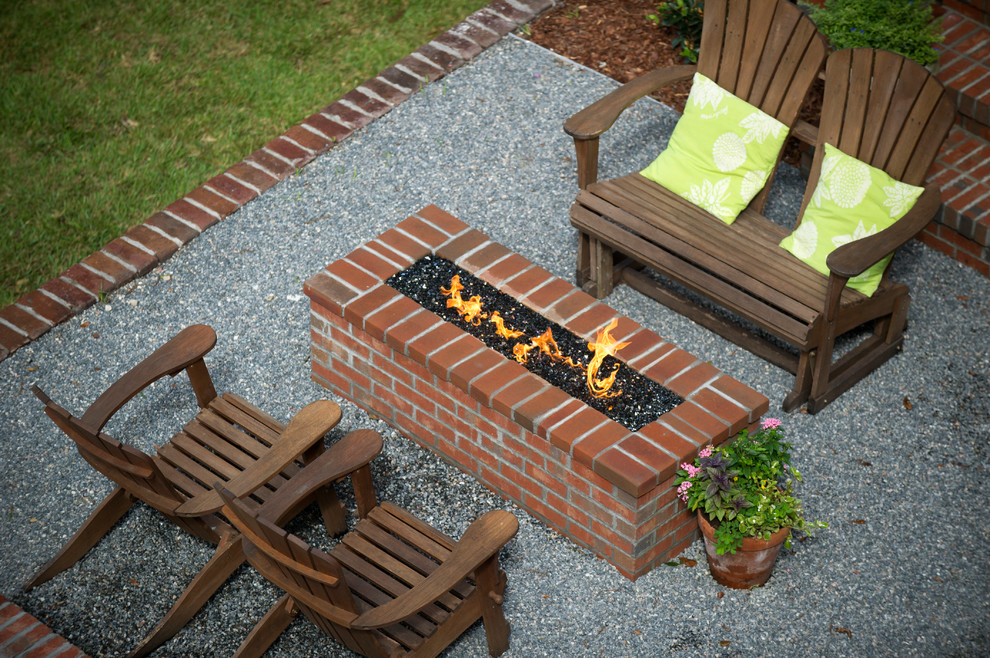 Small traditional back patio in Jacksonville with a fire feature, gravel and no cover.